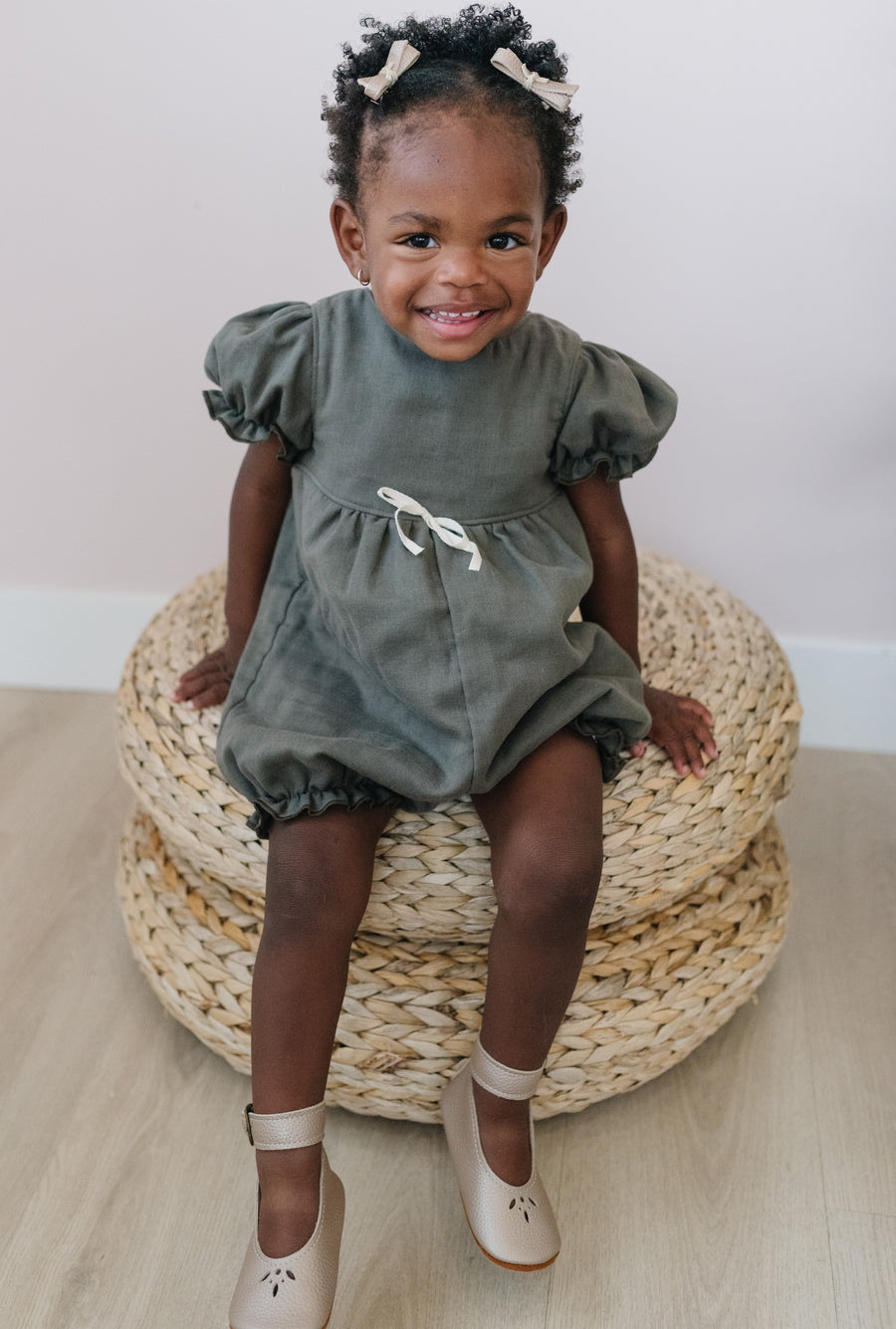 Child wearing Bows with Bloom Rompers and Ballerina shoes